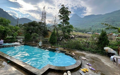 Poolside view of Sapa mountains during guided motorbike village tour, Cat Cat Village, Vietnam.