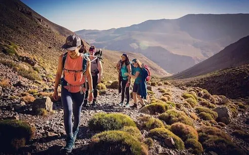 Hikers trekking along a rocky path in Atlas Mountains, Marrakesh.
