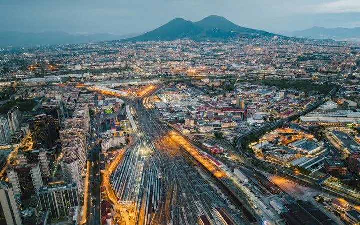 Aerial view of Naples with Mount Vesuvius in the background, part of a self-guided walking tour.