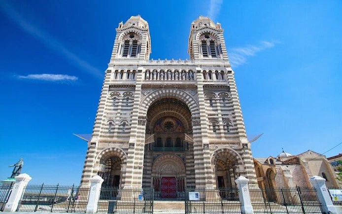 Marseille Cathedral facade under blue sky, part of self-guided city exploration game.