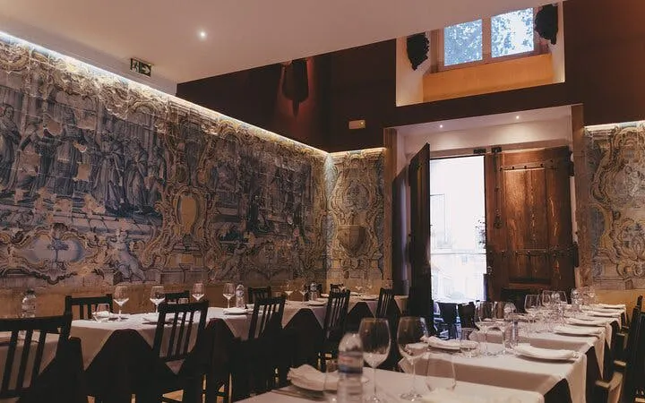 Portuguese dinner setup in Mesa de Frades Chapel, Lisbon, with traditional azulejo tiles.
