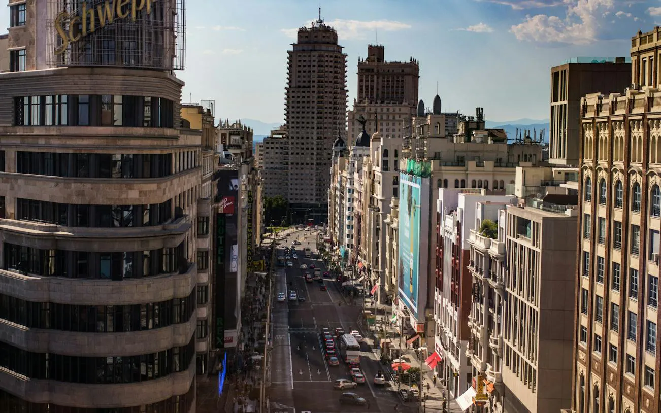 Gran Vía street view with Metrópolis and Telefónica buildings in Madrid.