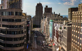Gran Vía street view with Metrópolis and Telefónica buildings in Madrid.