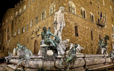 Fountain of Neptune at night in Piazza della Signoria, Florence.