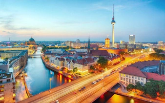Berlin skyline with TV Tower and Spree River at sunset, featured in self-guided walking tour app.