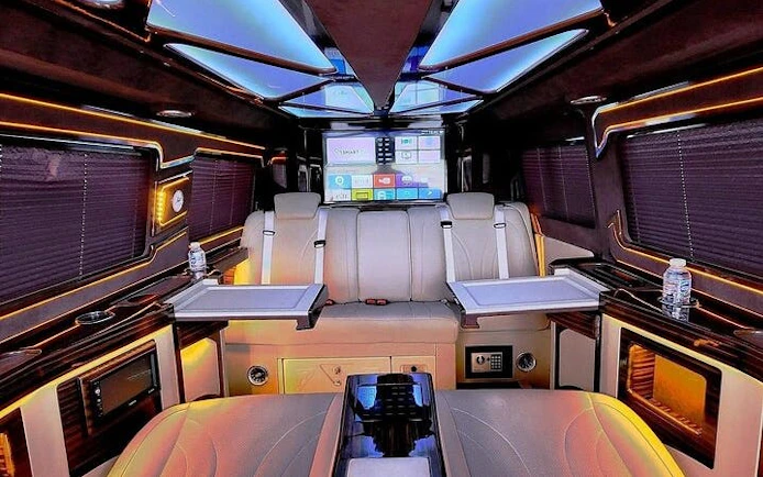 Luxury interior of a private transfer vehicle at Antalya Airport with seating and entertainment system.