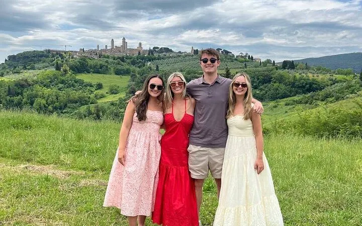 Tourists enjoying a view of San Gimignano's towers during a Chianti wineries tour.