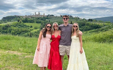Tourists enjoying a view of San Gimignano's towers during a Chianti wineries tour.