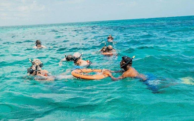 Snorkelers in clear blue water during a catamaran cruise in Punta Cana.
