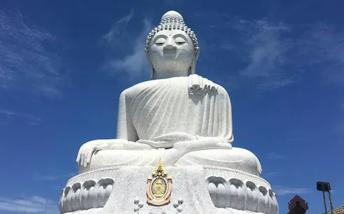 Big Buddha statue on Phuket Island under a clear blue sky.
