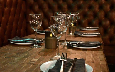 Private Icelandic restaurant table set for dinner with wine glasses and cutlery.