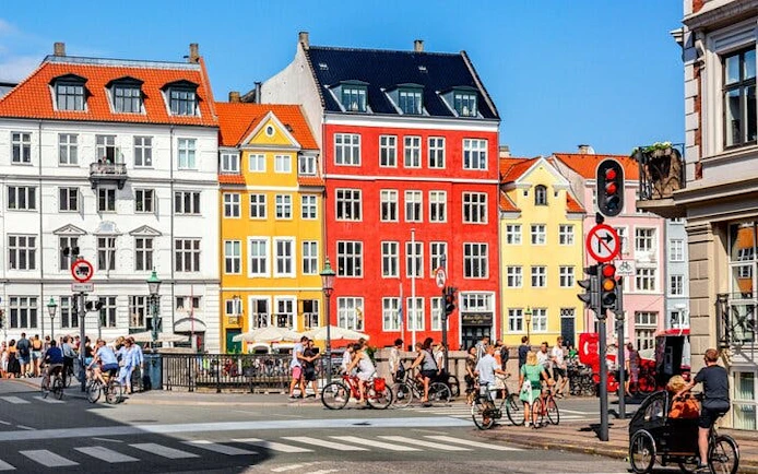 Colorful buildings and cyclists in Copenhagen city center.