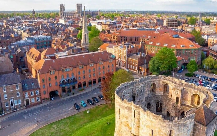 York cityscape with Clifford's Tower and York Minster, featured in self-guided walking tour app.
