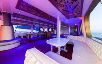 Luxurious interior of Alanya pirate boat with seating and ocean view.