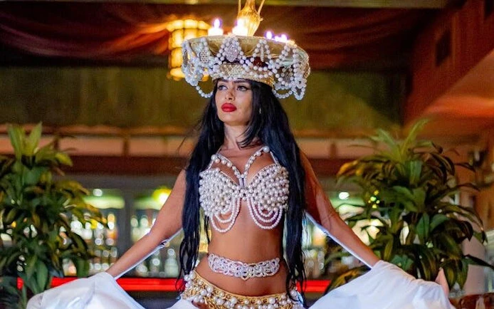 Cabaret performer with candle headpiece dancing at Hot Nights Live in Hurghada.