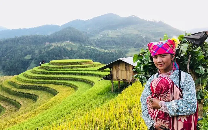Sapa rice terraces with local villager in traditional attire, Vietnam.