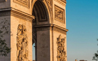 Arc de Triomphe close-up with detailed sculptures, Paris.