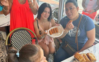 Tour group enjoying Cuban pastries at a café in Little Havana, Miami.