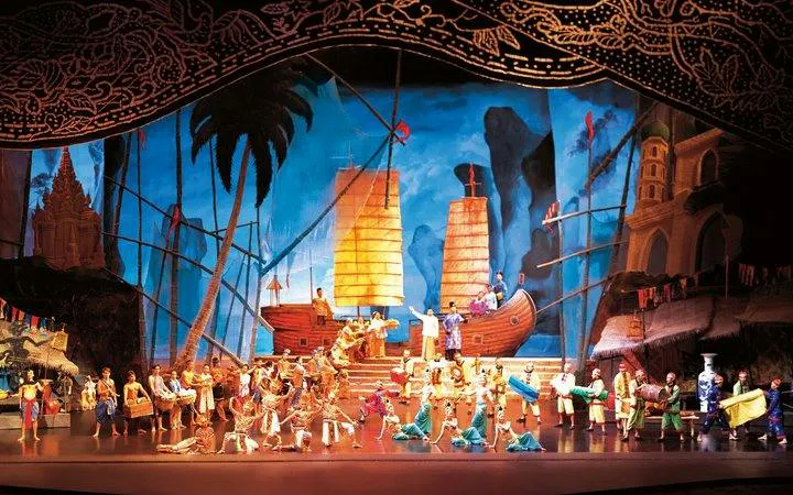 Performers on stage at Siam Niramit Phuket, depicting historical scenes with traditional costumes and ships.