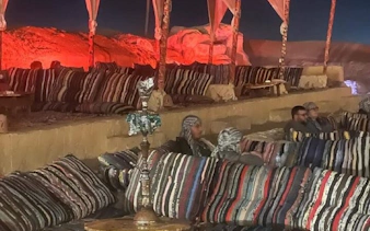 Bedouin seating area with cushions and hookah, Sharm El Sheikh stargazing and dinner show.