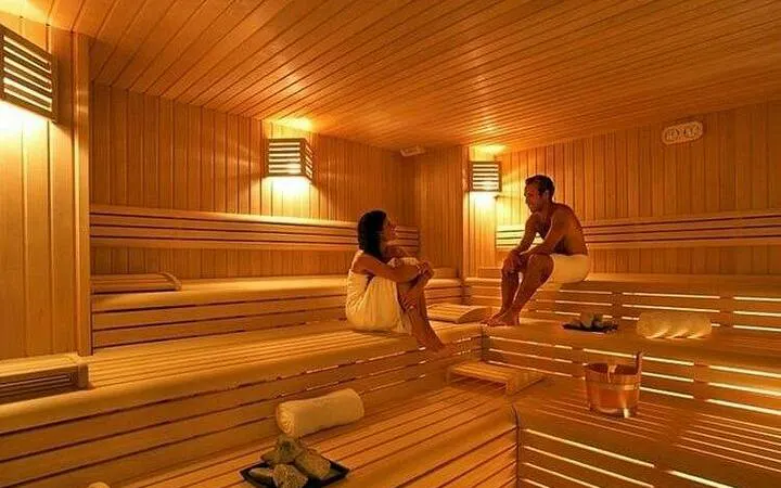 Couple enjoying sauna session at Alanya Hamam, part of Turkish bath rituals experience.