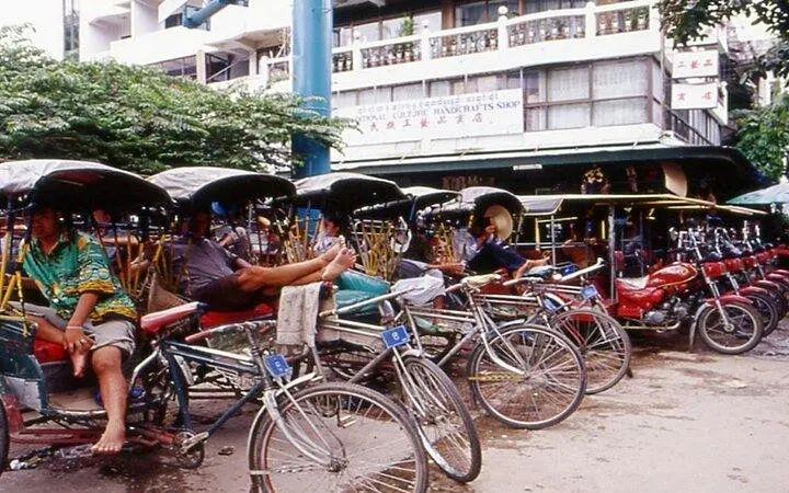 Rickshaws lined up in Chiang Rai city street near local market, part of guided tour from Chiang Mai.