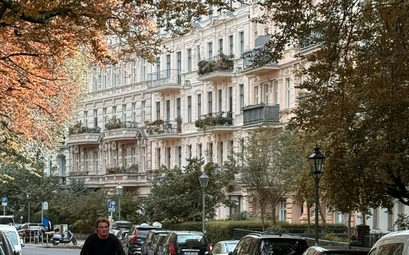Historic buildings along a tree-lined street in Kreuzberg, Berlin.