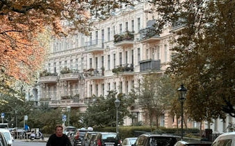 Historic buildings along a tree-lined street in Kreuzberg, Berlin.