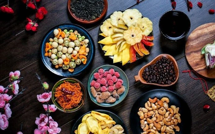 Sapa market tour showcasing local fruits, nuts, and spices arranged on a table.