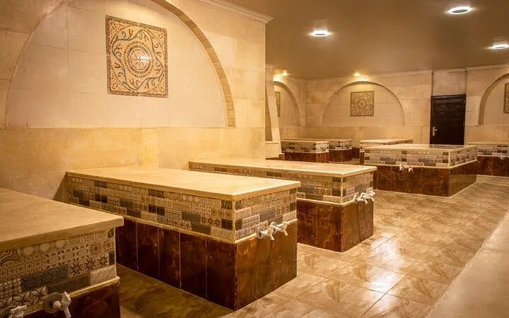 Traditional Moroccan hammam interior with tiled benches in Marrakech.