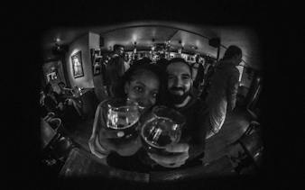 Reykjavík bar crawl participants toasting with drinks in a lively local bar.