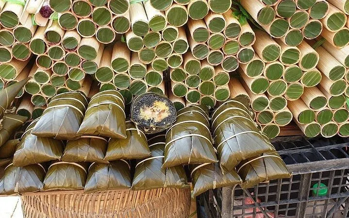 Bamboo tubes and wrapped rice cakes on display during Sapa food tour.
