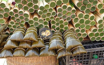 Bamboo tubes and wrapped rice cakes on display during Sapa food tour.