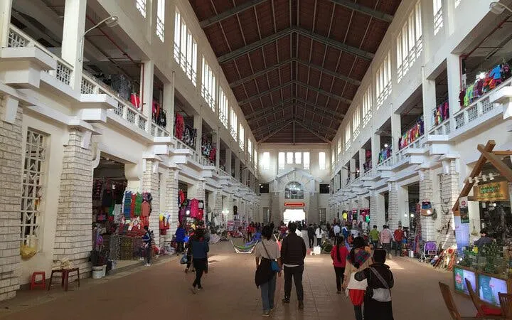 Indoor market in Sapa with visitors exploring local food stalls and colorful displays.