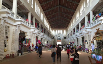 Indoor market in Sapa with visitors exploring local food stalls and colorful displays.