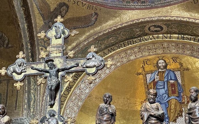St. Mark's Basilica interior with religious mosaics and crucifix, Venice tour.
