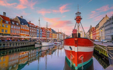 Nyhavn harbor with colorful buildings and boats, part of Copenhagen self-guided walking tour.