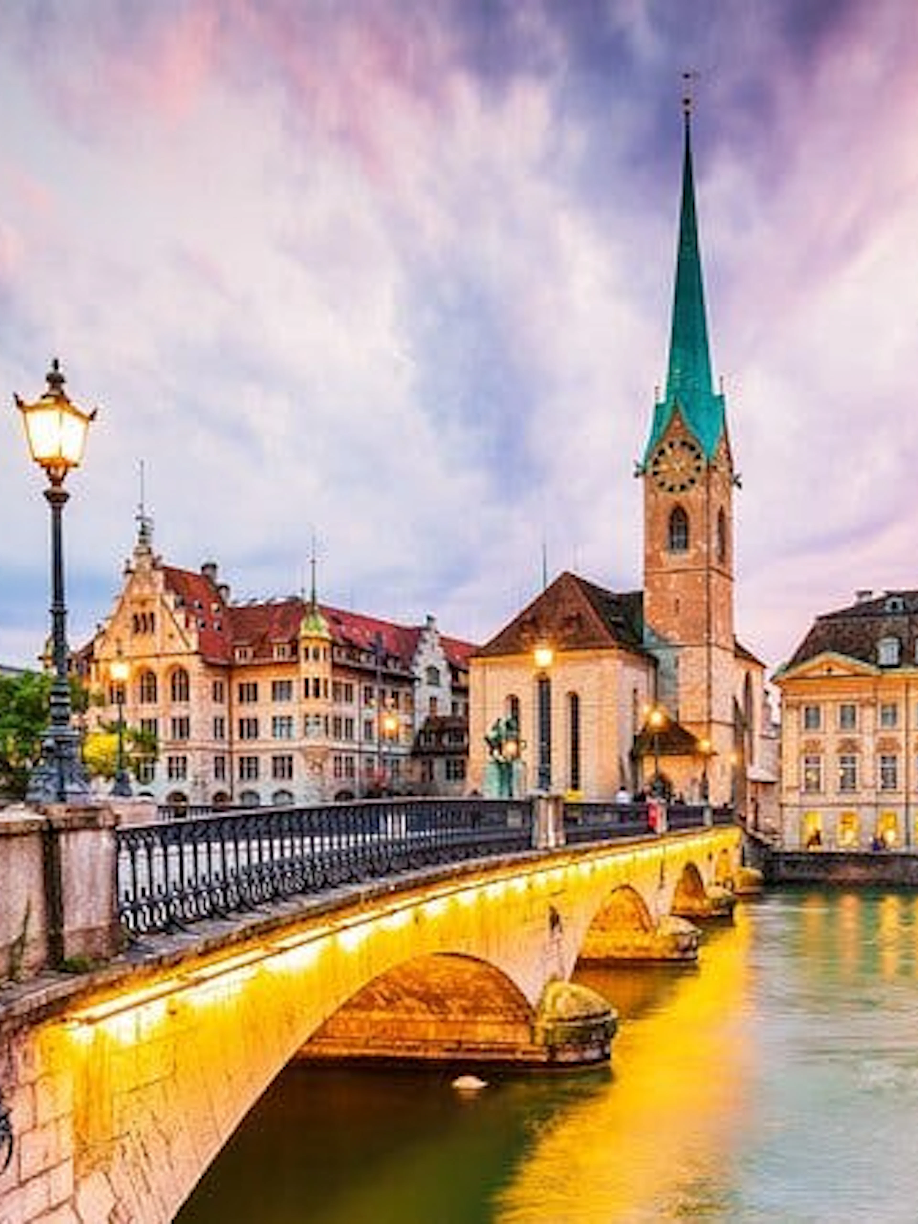Zurich's Fraumünster Church and bridge at sunset, part of Einstein's city exploration game.