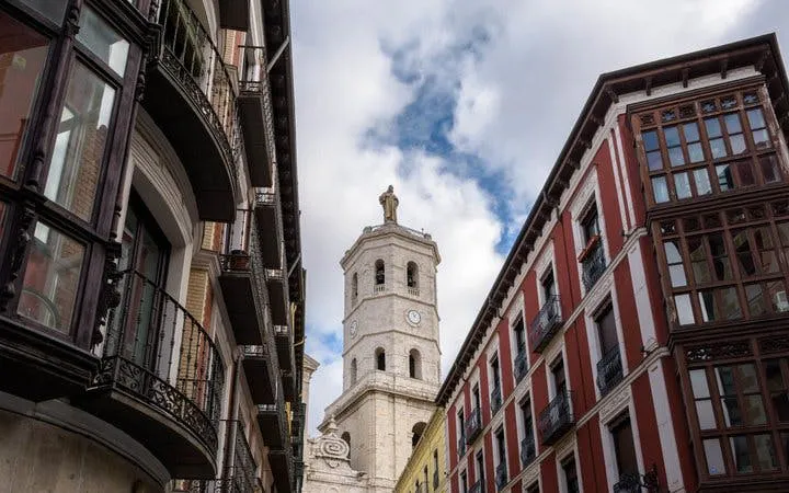 Valladolid cityscape with historic church tower and traditional buildings.