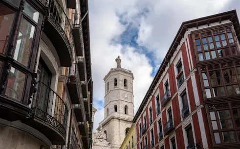 Valladolid cityscape with historic church tower and traditional buildings.