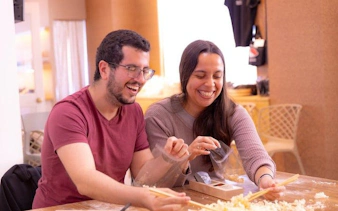 Chopstick-making workshop participants smiling in Osaka near Shinsaibashi and Dotonbori.