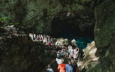 Tourists exploring a cave with a guided group in Santo Domingo, part of a day tour from Punta Cana.