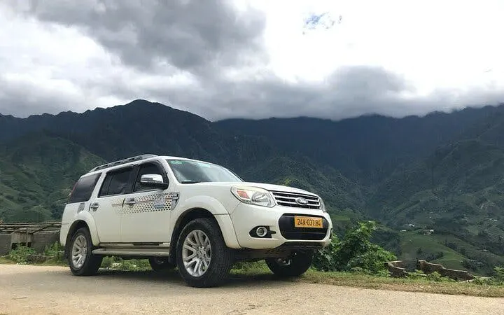 SUV on mountain road in Sapa for private transport to Mu Cang Chai with hotel service.