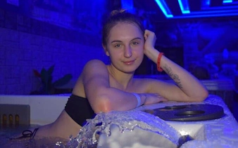 Person relaxing in a Turkish bath with blue lighting, Sharm El Sheikh.