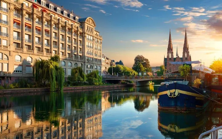 Strasbourg canal view with historic buildings and cathedral during self-guided walking tour.