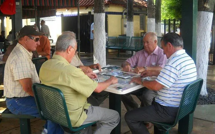 Men playing dominoes at a park in Little Havana, Miami, during a guided tour on Calle Ocho.