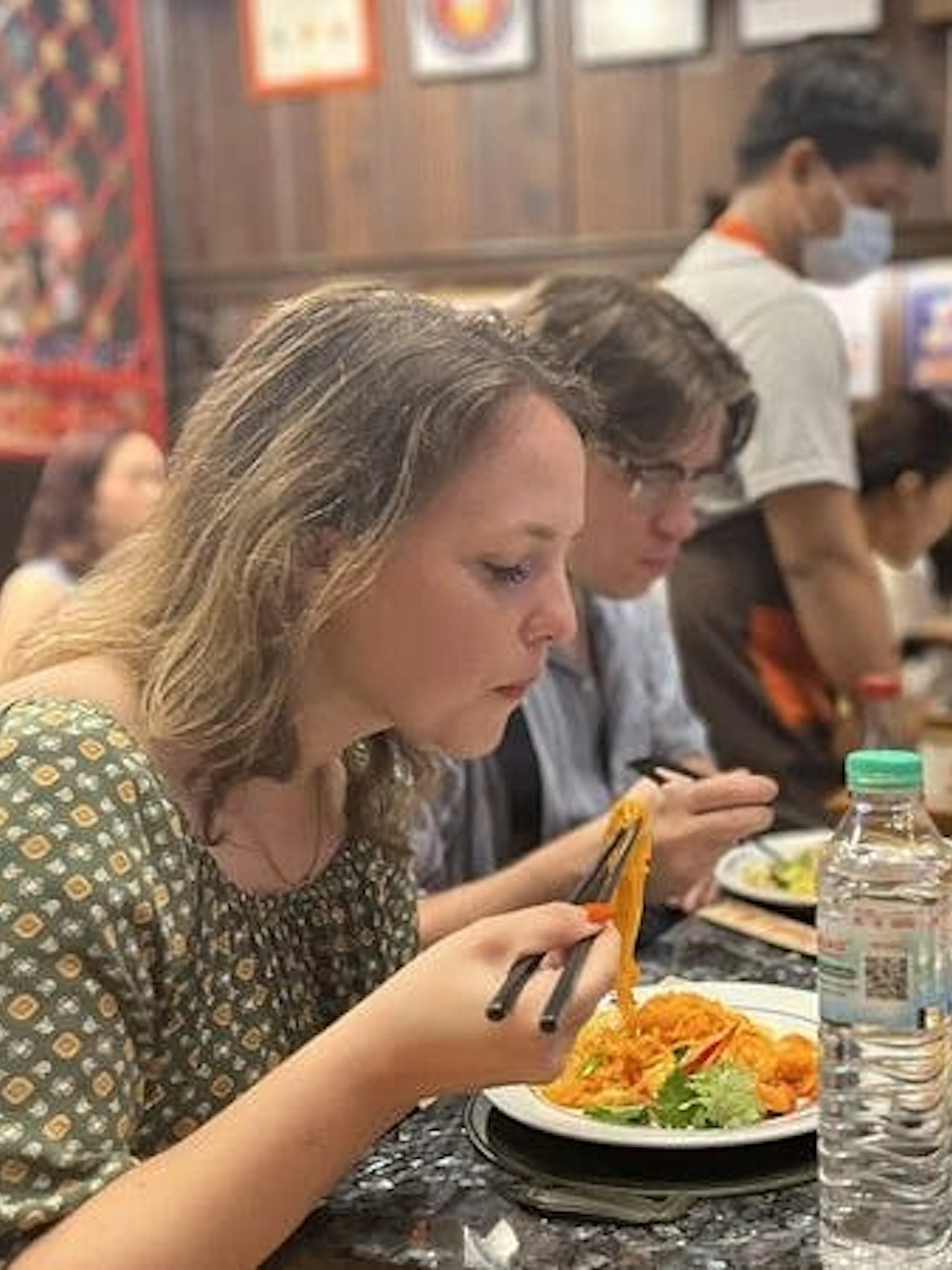Tourists enjoying a meal at a Michelin-recognized restaurant in Bangkok during a food tour.