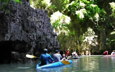 Sea kayaking through limestone cliffs in Phang Nga Bay, Phuket.