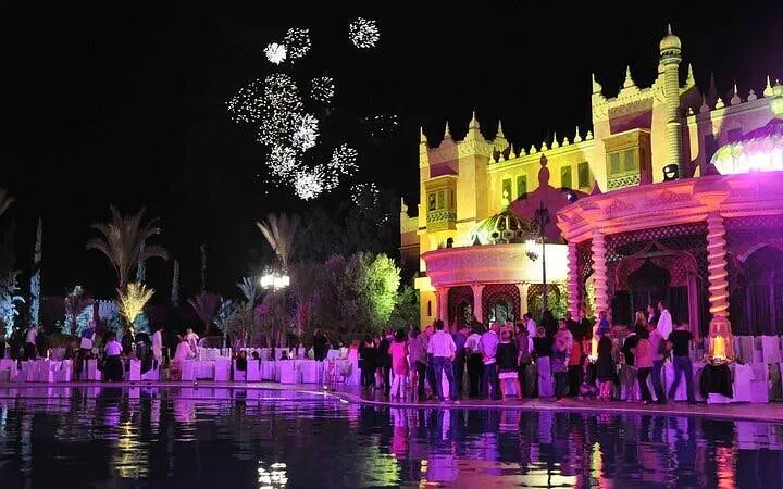 Chez-Ali dinner show with fireworks and illuminated palace in Marrakesh.