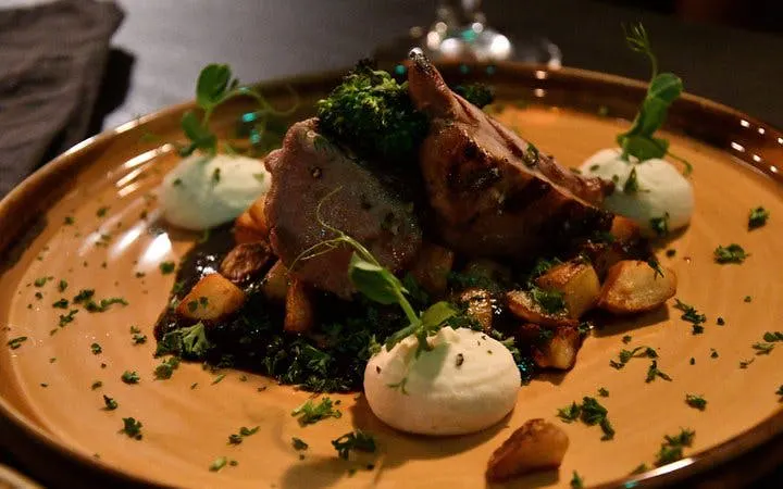 Grilled lamb with potatoes and greens at a private family-owned restaurant in Iceland.